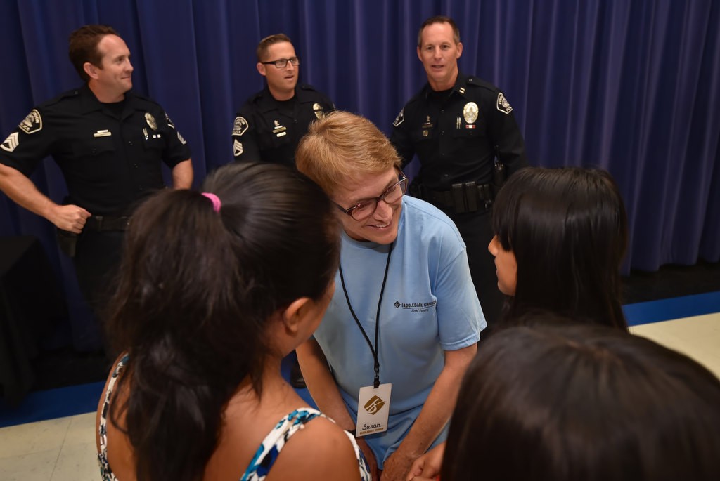 Susan Lacoff of Saddleback Church Anaheim talks to a group of girls behind honored by GRIP at Valencia Park Elementary School. Behind them are Fullerton PD’s Sgt. Joel Craft, left, Sgt. Jon Radus and Capt. (& acting Chief) John Siko. Photo by Steven Georges/Behind the Badge OC