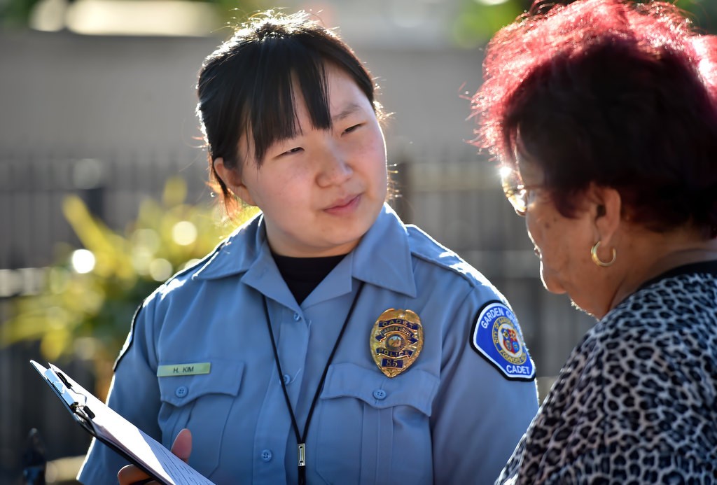 Garden Grove PD Cadet Han Na Park, who speaks Spanish and Korean in addition to English, conducts a survey on improvements and other issues with local residents during a Palma Vista/El Dorado Community Outreach Event. Photo by Steven Georges/Behind the Badge OC