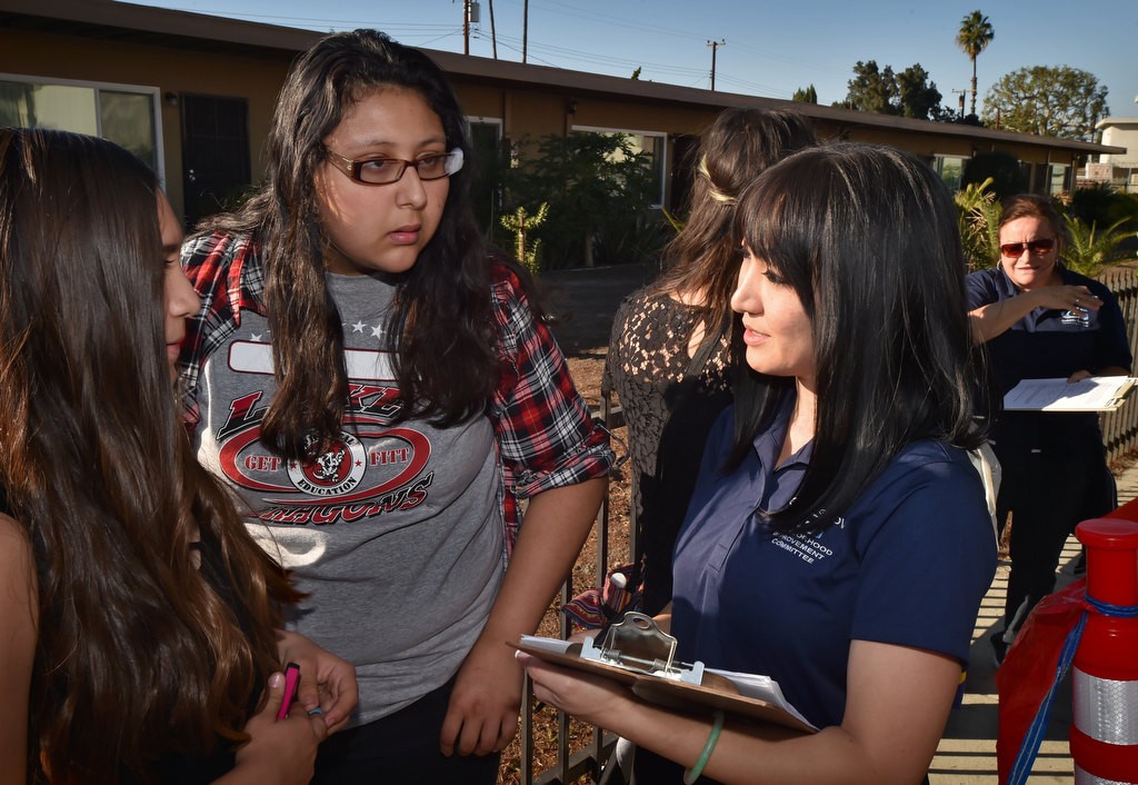 Alana Cheng, of the Garden Grove Neighborhood Improvement Committee, right, talks to local residents as she takes a survey on improvements and other issues during a Palma Vista/El Dorado Community Outreach Event. Photo by Steven Georges/Behind the Badge OC