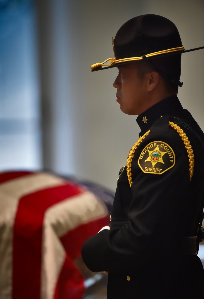 Orange County Sheriff Honor Guard Mong Chhith stands watch next to the flag draped casket of Deputy Courtney Ward who passed away from cancer earlier this month. Photo by Steven Georges/Behind the Badge OC