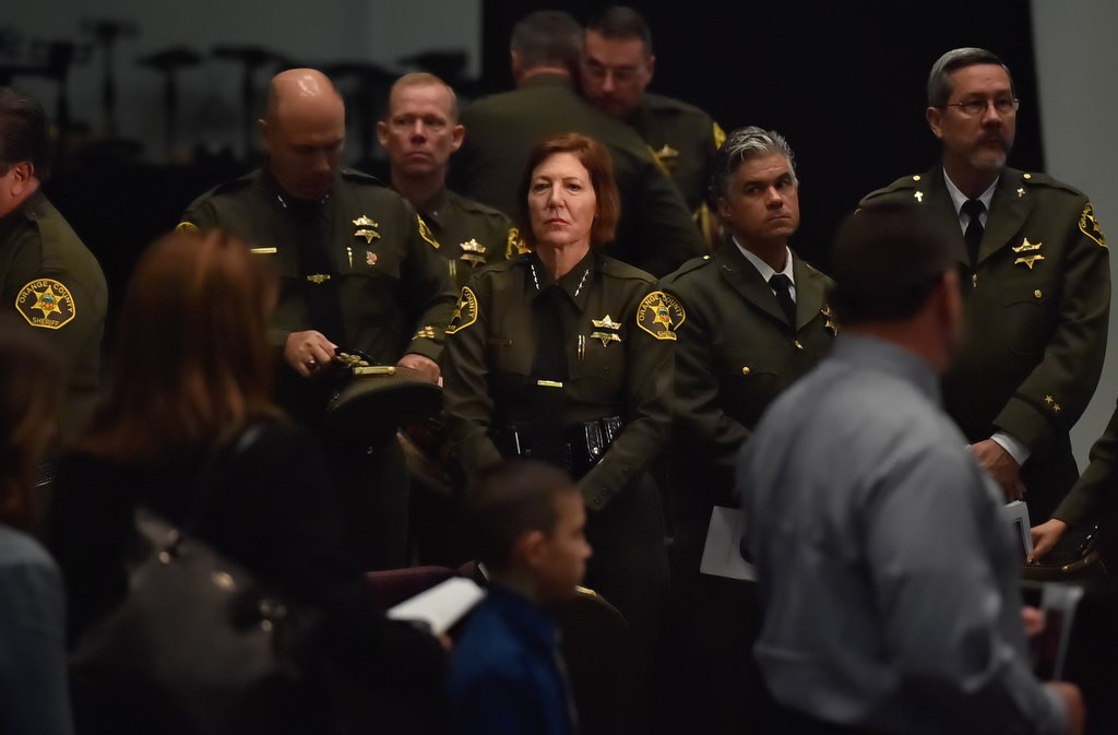Orange County Sheriff Sandra Hutchens, center watches as family and guest of Deputy Courtney Ward exit the church at the conclusion of funeral services. Photo by Steven Georges/Behind the Badge OC