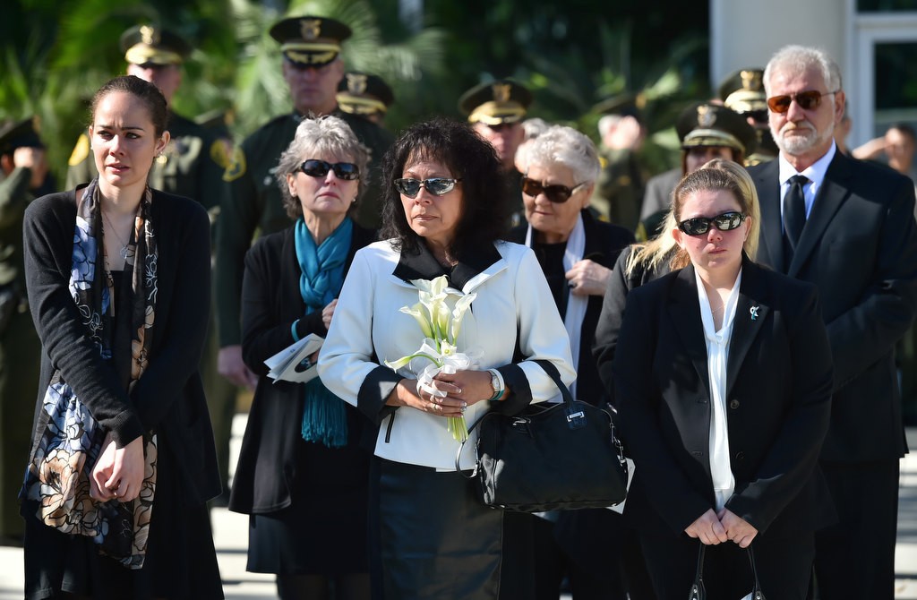 Courtney’s mother, Terri Horn, center leads a procession of family and deputies as Courtney Ward’s casket is carried from the church. From left is Jahlise Allen, Hugi Wallbridge, Terri Horn and Courtneys sister Lisa Todoroff. Photo by Steven Georges/Behind the Badge OC