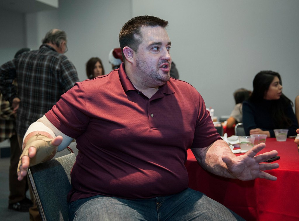 Jeremy Kelner reminisces with members of a support group attending Monday's annual party for burn survivors at the Anaheim Convention Center put on by the UC Irvine Health Regional Burn Center.  Keller came from Virginia after burning 60% of his body in a plane crash.