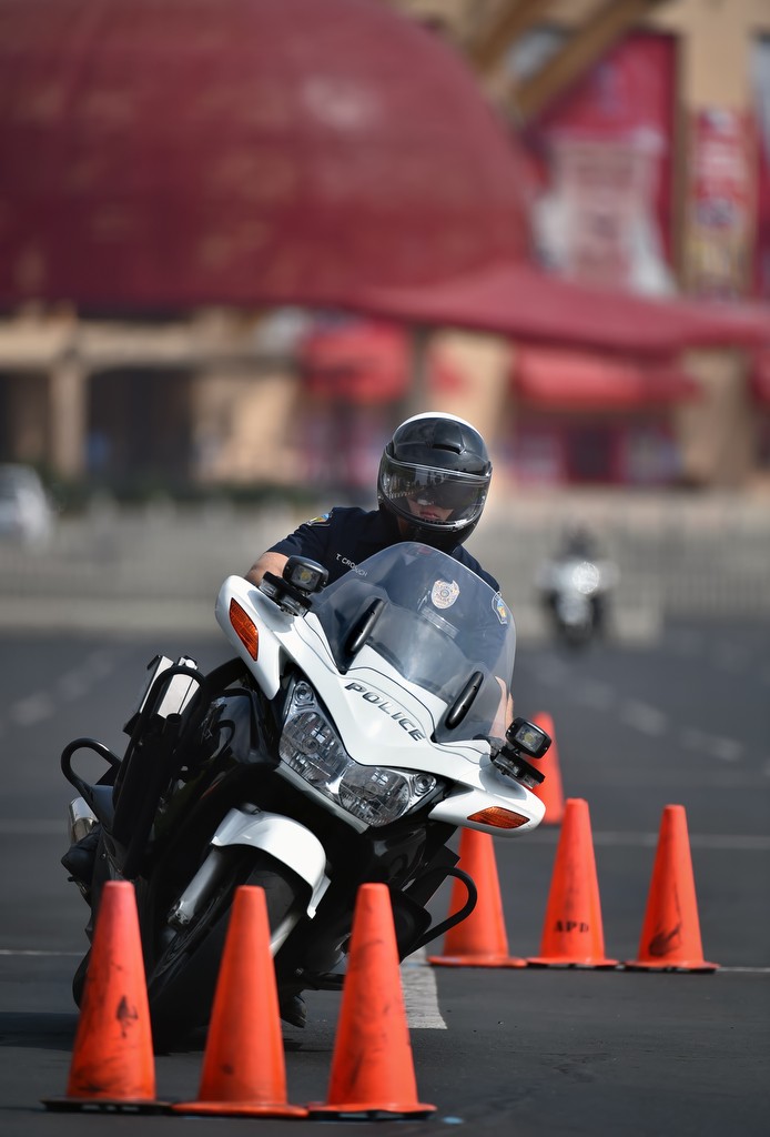 With Angels Stadium behind him, Tustin PD Officer Tim Crouch makes his way through the 30-cone weave during Anaheim PD's motor school. Photo by Steven Georges/Behind the Badge OC