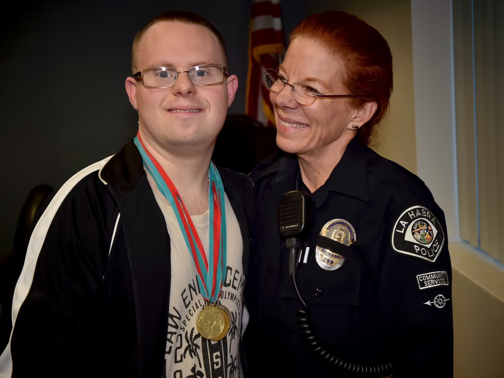Special Olympic medal winner John Blalock with La Habra PD’s Community Service Officer II Christina Nunez. Photo by Steven Georges/Behind the Badge OC