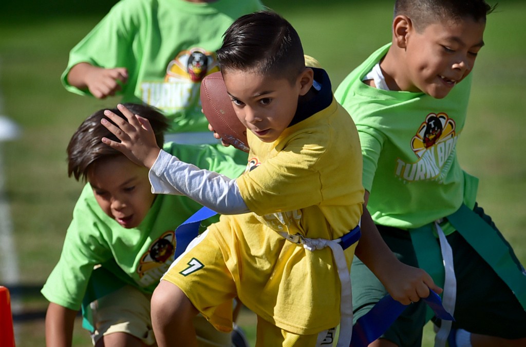 Kids participate in a flag football tournament coach by Tustin PD officers at Heideman Elementary. Photo by Steven Georges/Behind the Badge OC