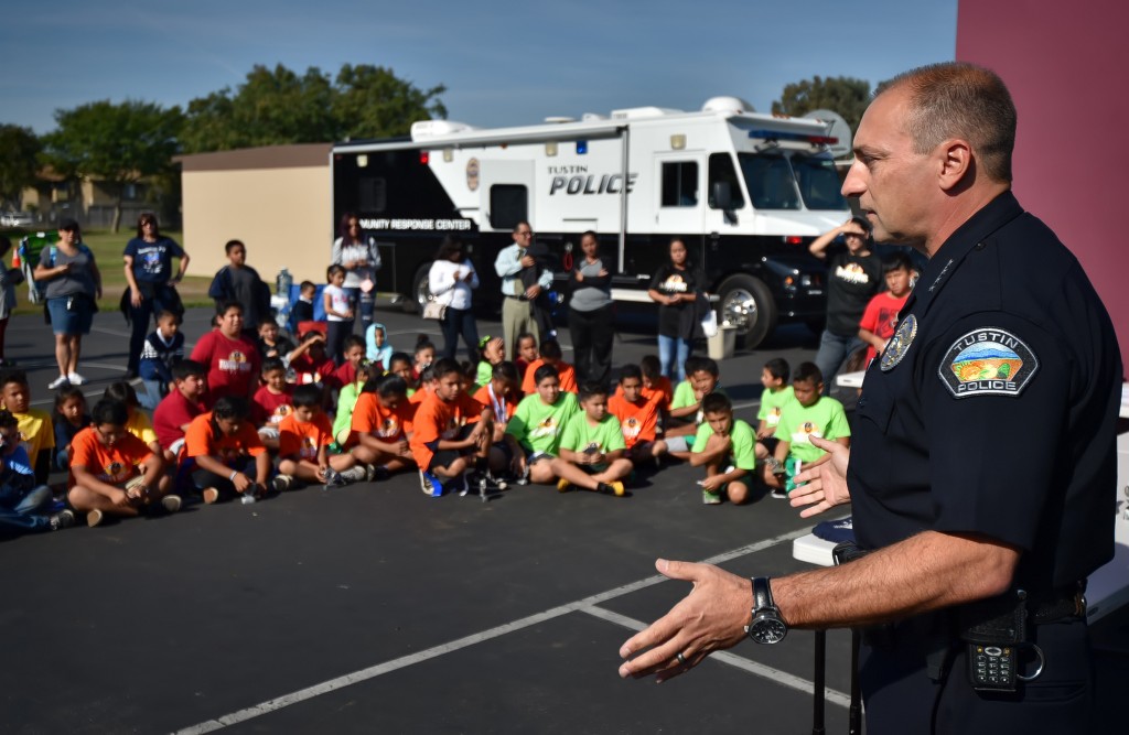 Tustin Police Chief Charles Celano talks to the flag football kids after a tournament at Heideman Elementary School. Photo by Steven Georges/Behind the Badge OC