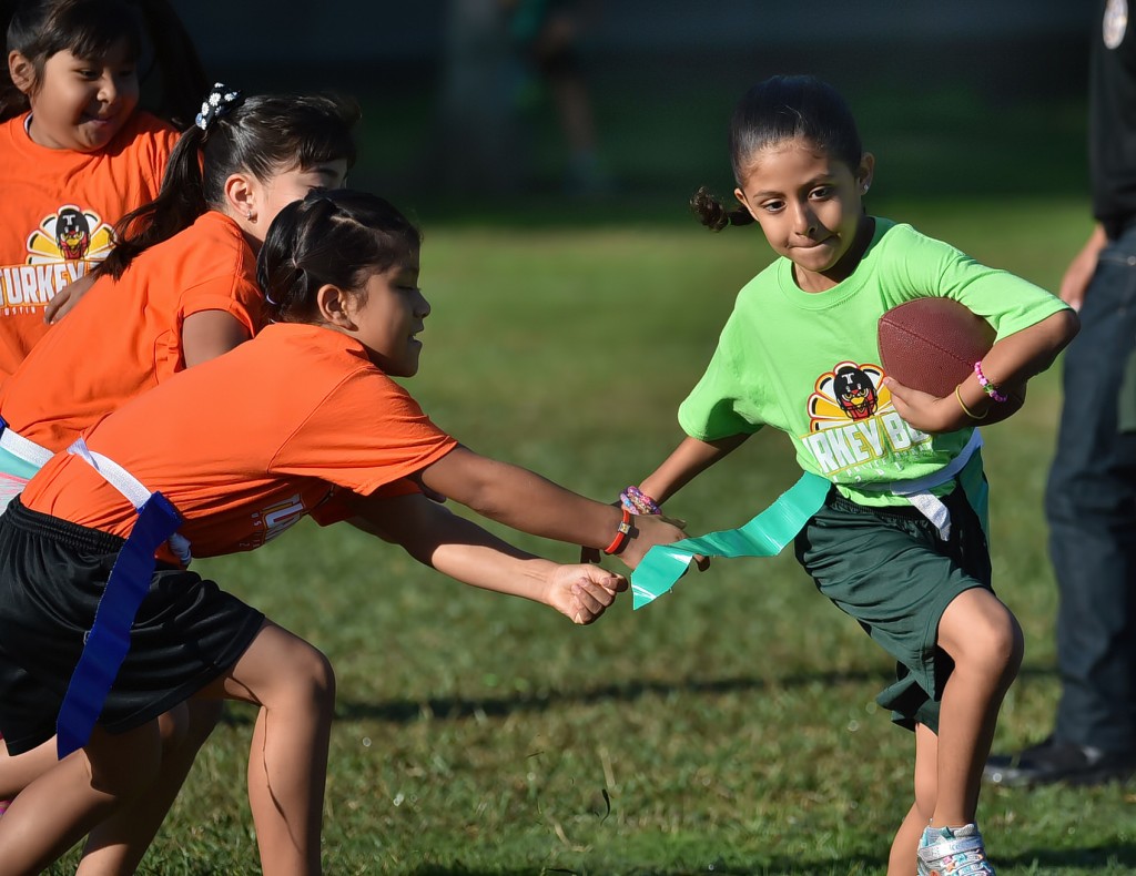 Kids play in a flag football tournament coached by Tustin PD officers at Heideman Elementary. Photo by Steven Georges/Behind the Badge OC