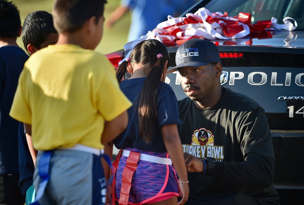 Tustin PD officers help coach a flag football league for students at Heideman Elementary in Tustin.