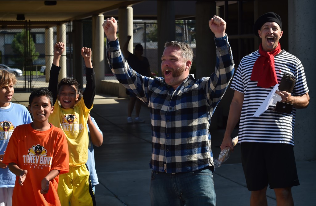 Jonathan Parker cheers with the kids as he receives most creative mustache during the Tustin Police Office Association’s Stache for Cash mustache growing fundraiser contest. Photo by Steven Georges/Behind the Badge OC