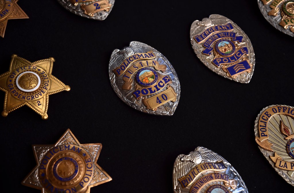 Stan Berry’s collection of old police badges including some that say “Policeman” instead of Police Officer.” Photo by Steven Georges/Behind the Badge OC