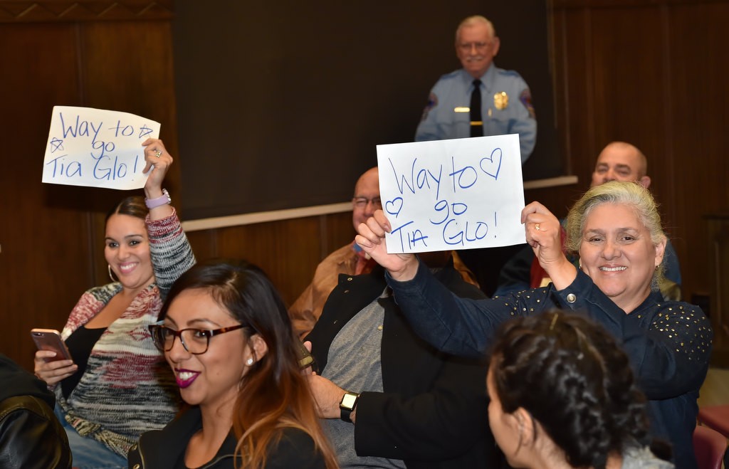 Friends of Fullerton PD’s Citizen’s Police Academy graduate Gloria Milhan hold up signs as she receives her certificate. Photo by Steven Georges/Behind the Badge OC