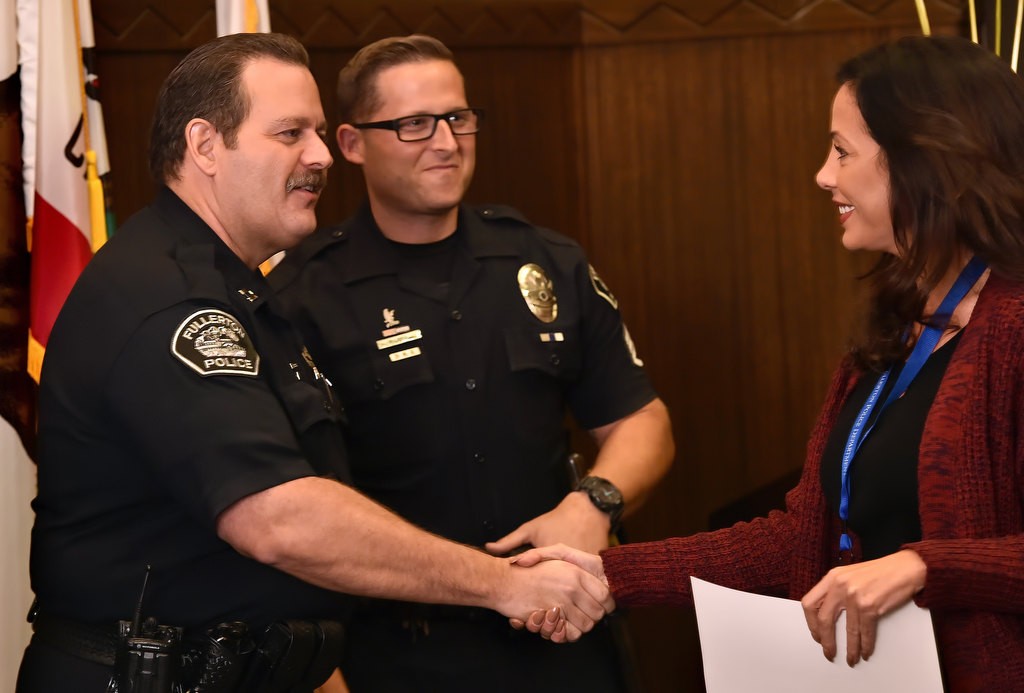 Fullerton PD Capt. Scott Rudisil, left, and Sgt. Jon Radus congratulate Audrey DalSoglio as she receives her certificate during the Citizen’s Police Academy class of fifteen graduation. Photo by Steven Georges/Behind the Badge OC
