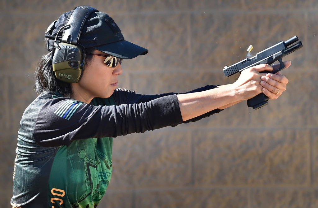 OC Sheriff Dep. Susan Huang hits her targets as the shell casings fly during competition at the Prado Olympic Shooting Park in Chino. Photo by Steven Georges/Behind the Badge OC
