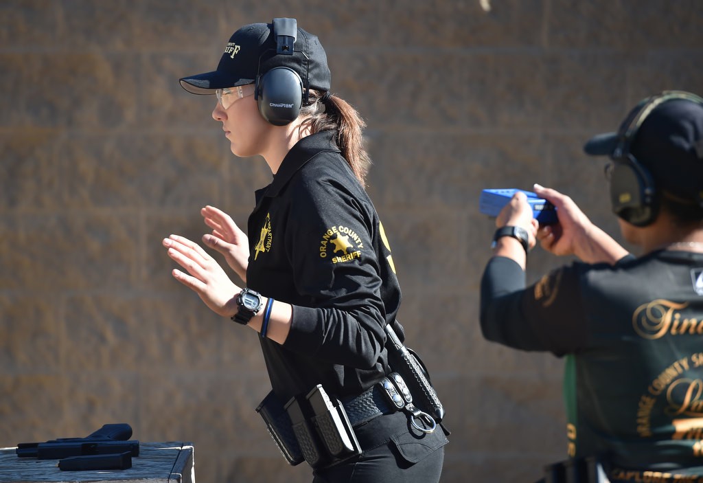 OC Sheriff Dep. Dallas Mihalik stands ready for her set of targets as Special Officer Jean Tindugan holds the blue shot clock behind her. Photo by Steven Georges/Behind the Badge OC