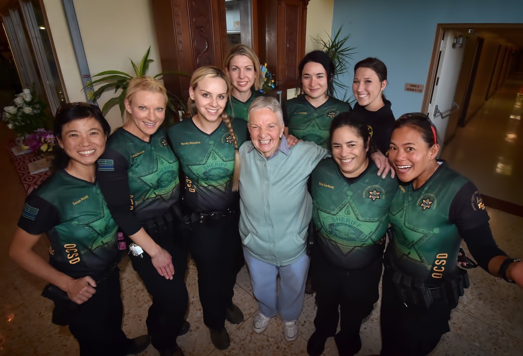 Some members of the OC Sheriff Department's Ladies' Trigger Team visit Alice Chandler, OCSD's first female deputy, after their target shoot at the Prado Olympic Shooting Park on Sunday, Dec. 4. The team, from left, is Susan Huang, Dana Chaney, Norelly MejiaZea, Carla Dane, (Alice Chandler), Maria Bowman, Gina Garduno, Dallas Mihalik and Jean Tindugan. Photo by Steven Georges/Behind the Badge OC