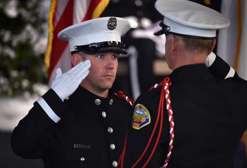 OCFA Honor Guard Bryan Dodson, left, salutes Cliff Bramlette during a memorial service for Santa Ana/OCFA Firefighter Ron Castro. Photo by Steven Georges/Behind the Badge OC