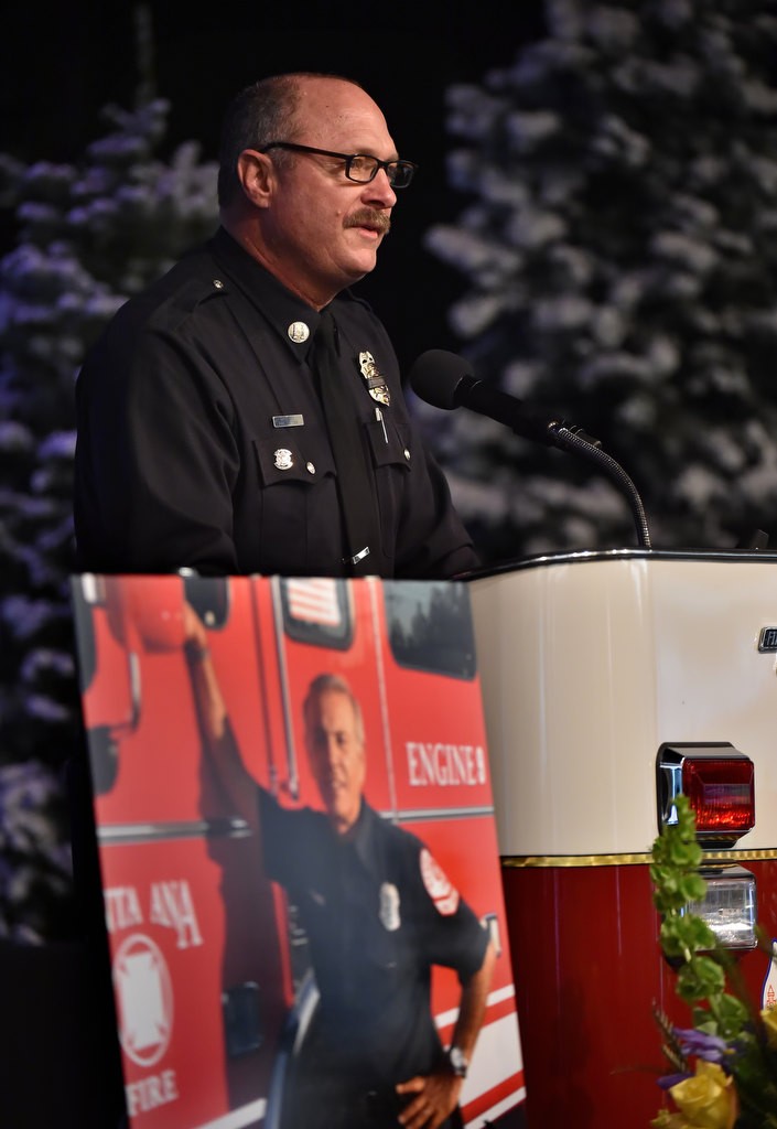 OCFA Fire Captain Mark Eide talks in front of a photo of Santa Ana/OCFA Firefighter Ron Castro during his memorial service at Calvary Chapel in Santa Ana. Photo by Steven Georges/Behind the Badge OC