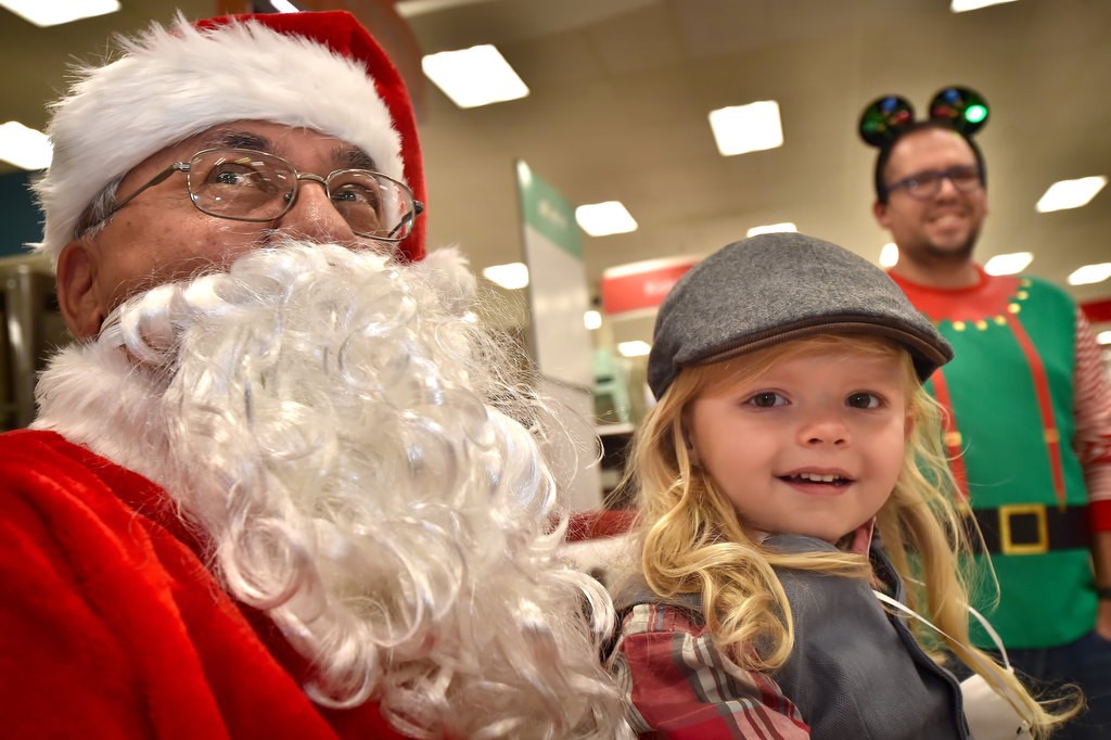 Four-year-old Cy Callan takes his turn with Santa before going through the Target store with OC Sheriff’s Deputies for the Shop with a Deputy event. Photo by Steven Georges/Behind the Badge OC