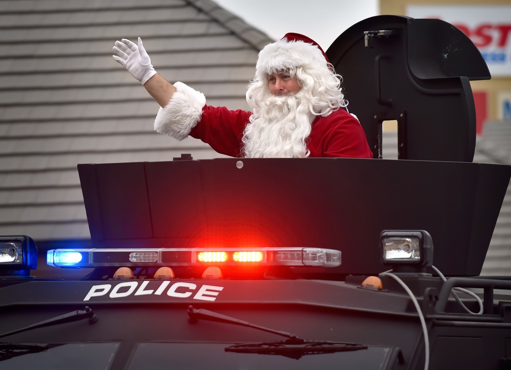 Santa arrives on top of a Westminster PD BearCat SWAT vehicle for the PD’s annual Shop with a Cop. Photo by Steven Georges/Behind the Badge OC