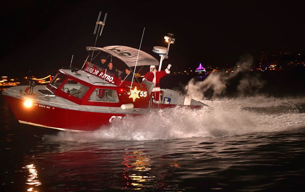 Santa arrives on board the OCSD’s Harbor Partrol fire boat for the Make A Wish Holiday Harbor Cruise. Photo by Steven Georges/Behind the Badge OC