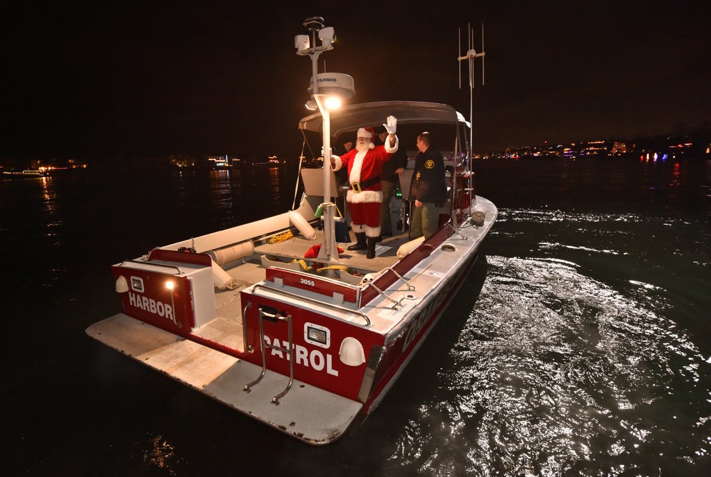 Santa arrives on board the OCSD’s Harbor Partrol fire boat for the Make A Wish Holiday Harbor Cruise. Photo by Steven Georges/Behind the Badge OC