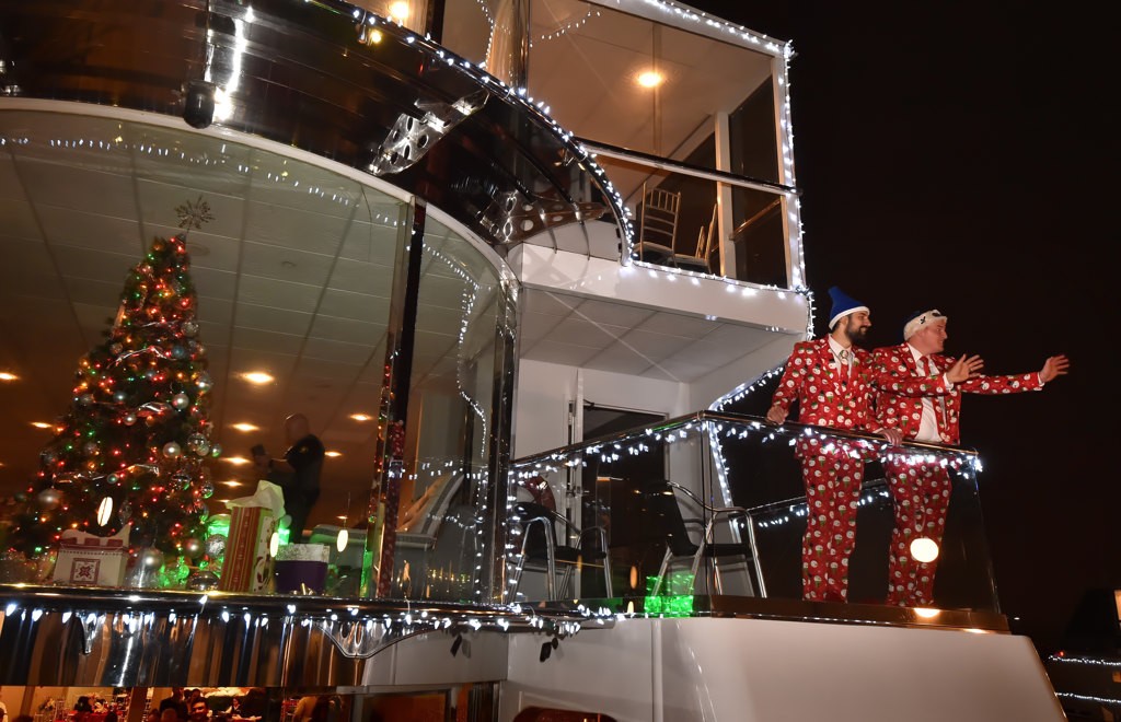 Jake Koeppel and Max Werderman, right, wave farewell to the Male-A-Wish kids at the conclusion of their Holiday Harbor Cruse. Photo by Steven Georges/Behind the Badge OC