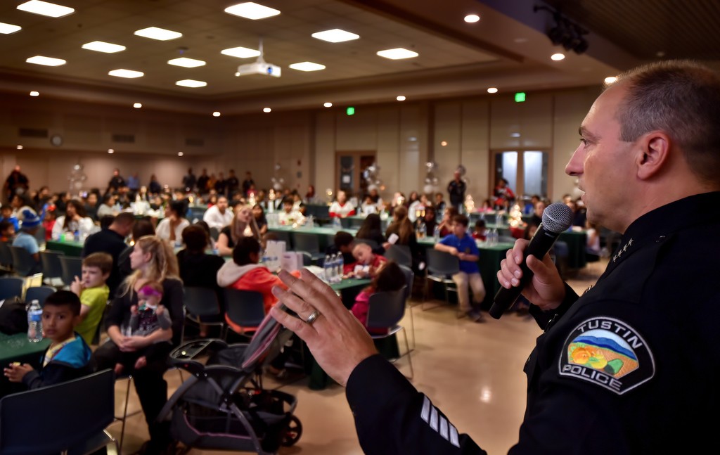 Tustin Police Chief Charles Celano welcomes local families to Tustin PD’s annual Santa Cop gathering at the Tustin Community Center. Photo by Steven Georges/Behind the Badge OC