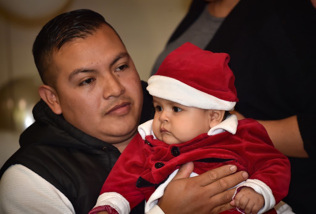 Seven-month-old Christopher Hernandez arrives with his dad Antonio Hernandez for Tustin PD’s annual Santa Cop gathering. Photo by Steven Georges/Behind the Badge OC