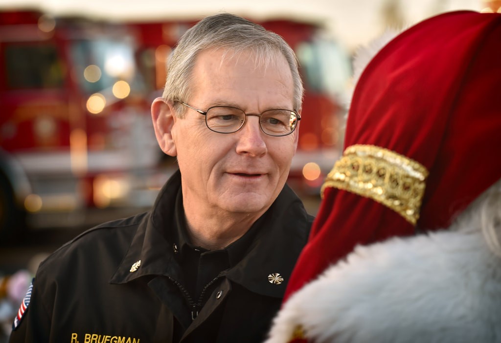 Anaheim Fire & Rescue Chief Randy Bruegman talks to Santa at the Spark of Love Toy Drive. Photo by Steven Georges/Behind the Badge OC