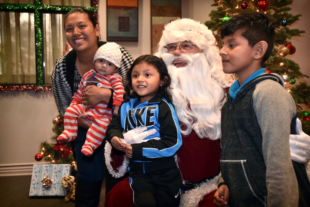 Families get a chance to meet Santa during the OCFJC Adopt A Family gathering. Photo by Steven Georges/Behind the Badge OC
