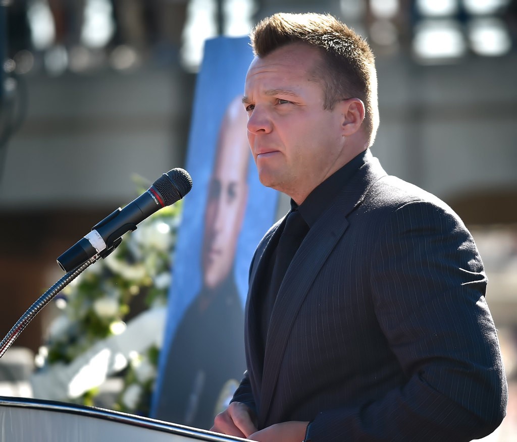 Erik Brown, talks about his lifelong friend, Capt. Eric Weuve, during a memorial service next to the Huntington Beach Pier. Photo by Steven Georges/Behind the Badge OC