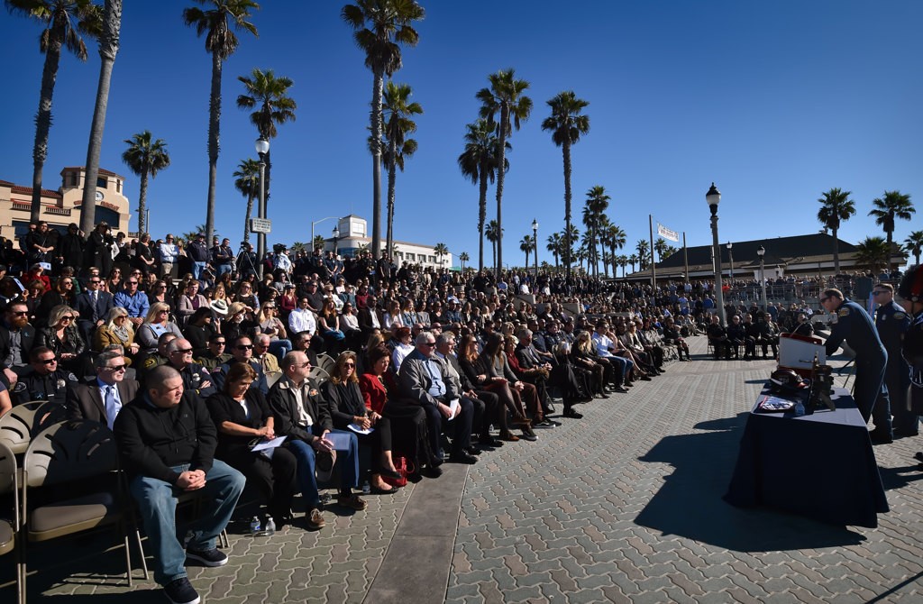 OCFA Capt. Matthew Schuetz talks about his friend and colleague, Capt. Eric Weuve, during a memorial service at Huntington Beach Pier Plaza. Photo by Steven Georges/Behind the Badge OC