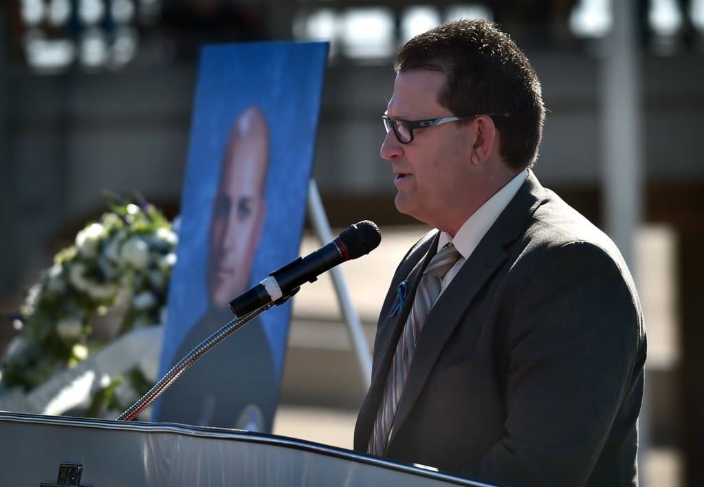 Ken Gabrielson talks about OCFA Capt. Eric Weuve during a memorial service at the base of the Huntington Beach Pier. Photo by Steven Georges/Behind the Badge OC