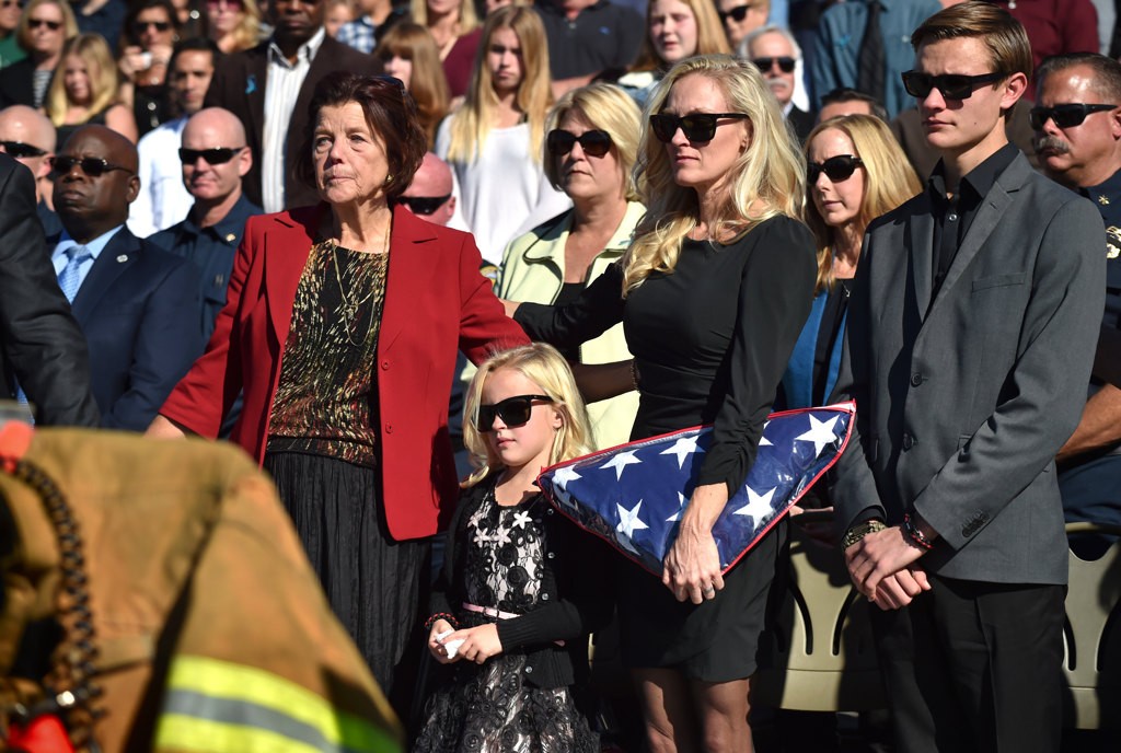 Ingrid Weuve, mother of OCFA Capt. Eric Weuve, left, stands with Capt. Weuve’s 6-year-old daughter, Brooklyn, his wife Melanie and their son Parker, 14, during a memorial service for Capt. Weuve. Photo by Steven Georges/Behind the Badge OC