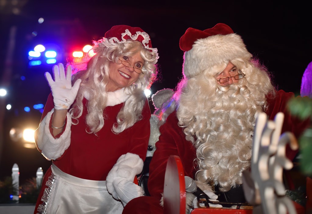 Santa and Mrs. Claus wave at motorist as they are escorted by the Tustin PD to visit the kids of Tustin. Photo by Steven Georges/Behind the Badge OC