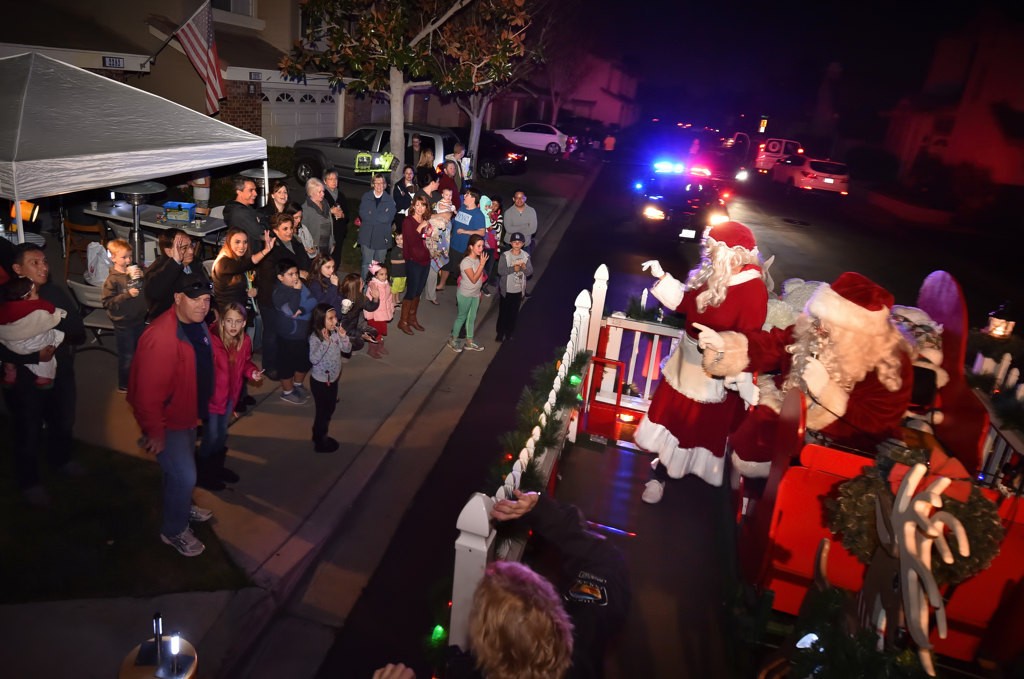 Santa’s sleigh arrives in their neighborhood escorted by the Tustin PD. Photo by Steven Georges/Behind the Badge OC