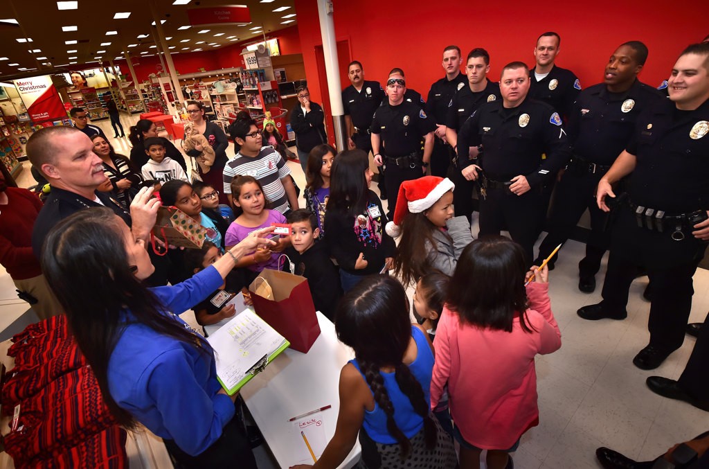 Garden Grove Police Chief Todd Elgin introduces the officers who volunteered their time to help out to the kids at the start of GGPD’s Shop with a Cop event at the Target on Harbor Blvd. Photo by Steven Georges/Behind the Badge OC