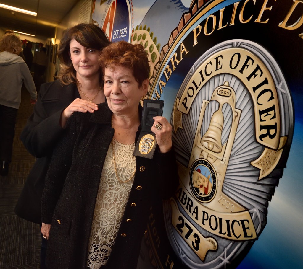 Margarita Osornio, left, and Guadalupe Osornio, sister and mother of La Habra Police officer Michael Osornio who died while on duty in 1994, stand next to La Habra’s new mural that features a badge with his number, 273, on it. The mother, who’s family was invited to the unveiling, brought his badge to the ceremony. Photo by Steven Georges/Behind the Badge OC