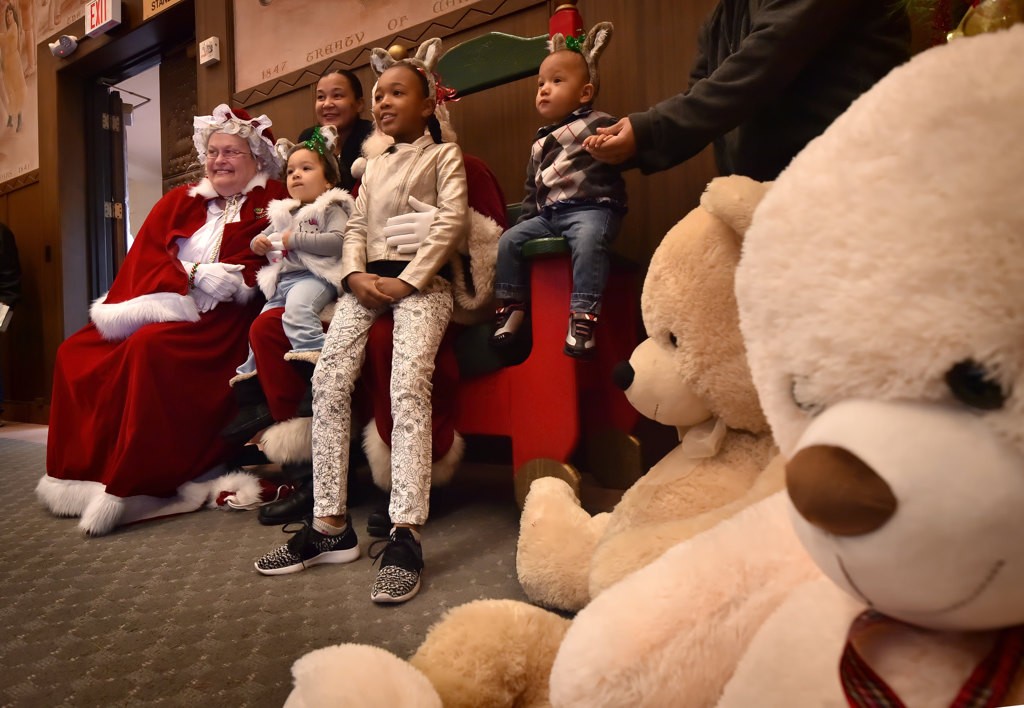 Each family in Fullerton PD”s Adopt a Family holiday program gets their photo taken with Santa and Mrs. Claus. Photo by Steven Georges/Behind the Badge OC