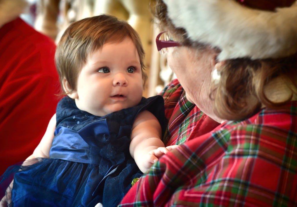 Isabella Vazquez, 4 months Four-month-old Isabella Vazquez is fixated on Mrs. Claus as kids line up to visit Santa during Anaheim’s Community Holiday Brunch. Photo by Steven Georges/Behind the Badge OC