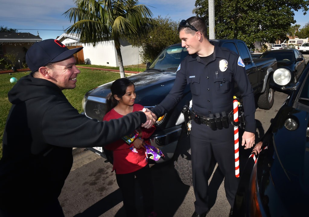 Garden Grove PD Officer John Yergler receives a thank you after delivering donated Christmas gifts to his family. Photo by Steven Georges/Behind the Badge OC