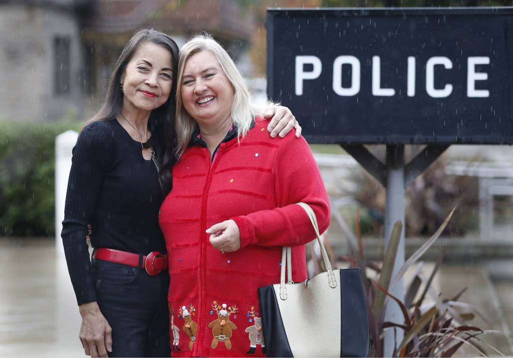 Garden Grove Community Liaison, Cindy Nagamatsu Hanlon, left, helped arrange a visit by Karen Hatfield, right, to the Garden Grove Police Department. Karen delivered homemade desserts to the department.   Photo by Christine Cotter/Behind the Badge OC