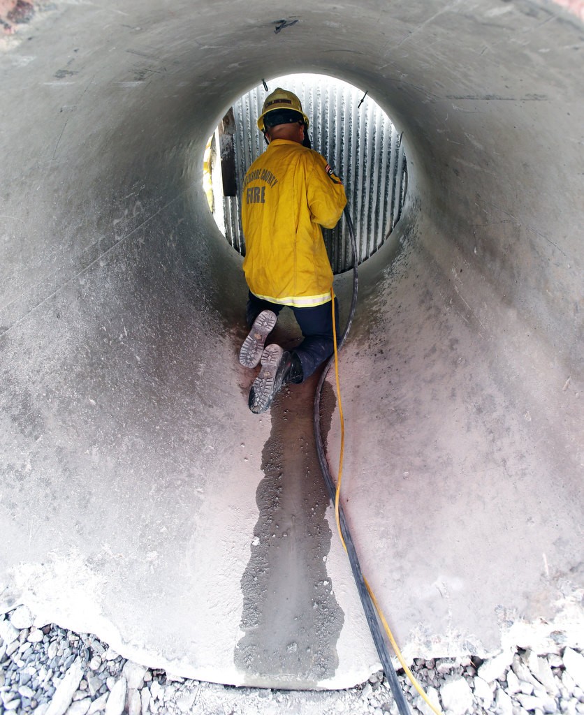 Riverside County firefighter xxx Calderon uses a core drill to cut through a concrete wall during a training exercise at North Net Training Center in Anaheim. Photo by Christine Cotter