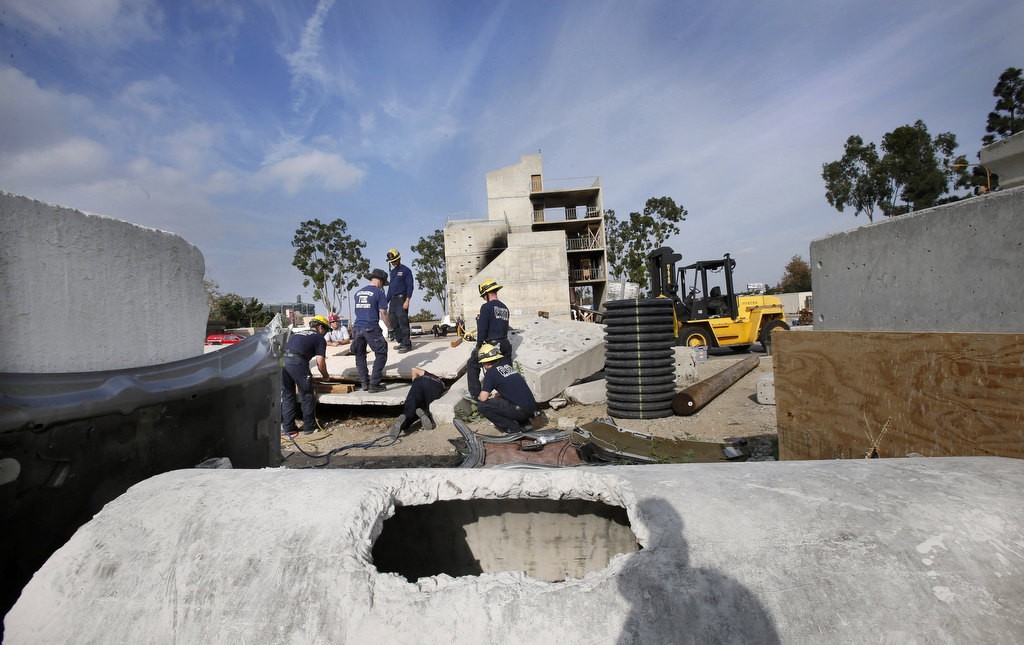 Firefighters search beneath concrete slabs in a training exercise at North Net Training Center in Anaheim. Photo by Christine Cotter
