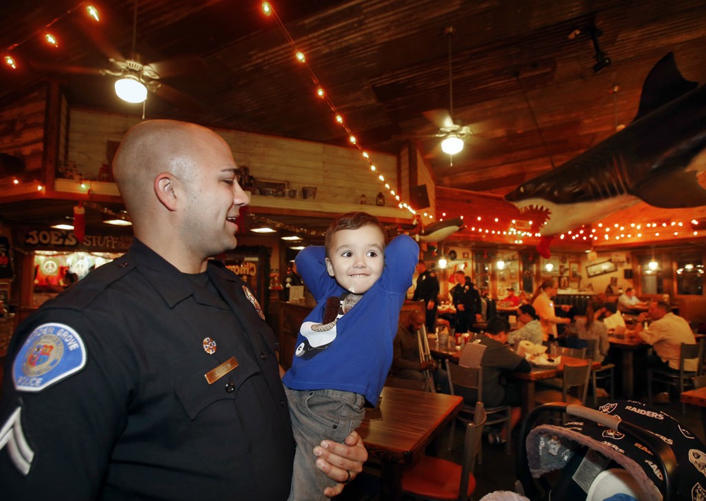 Garden Grover officer Nick Jensen and son Noah at a Special Olympics fundraiser at Joe's Crab Shack. Photo by Christine Cotter