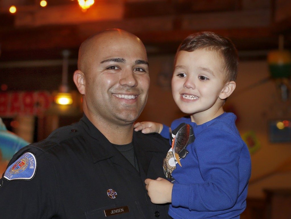 Garden Grover Officer Nick Jensen with son Noah during a Special Olympics fundraiser at Joe's Crab Shack. Photo by Christine Cotter