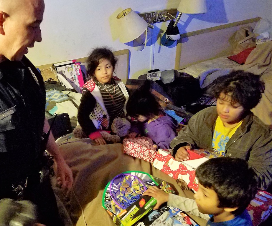Garden Grove PD Officer John Yergler receives a thank you after delivering donated Christmas gifts to his family. Photo by Steven Georges/Behind the Badge OC