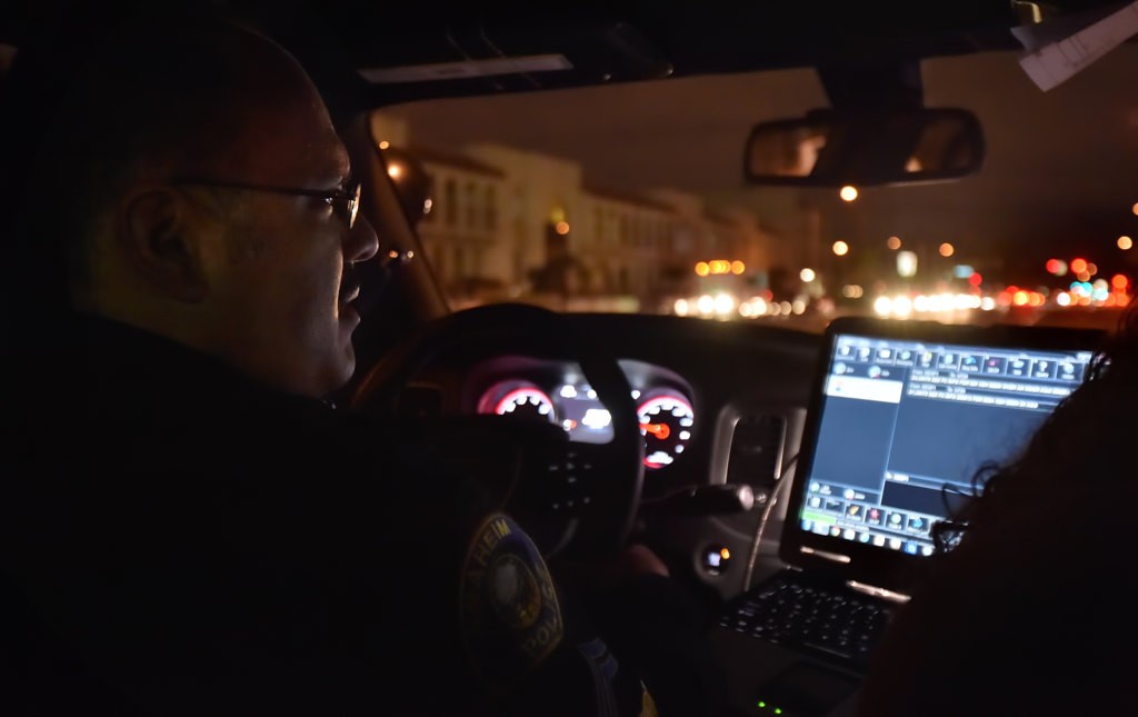 Officer John Roman, a Traffic Investigator for the Anaheim PD, drives the streets of Anaheim an night. Photo by Steven Georges/Behind the Badge OC