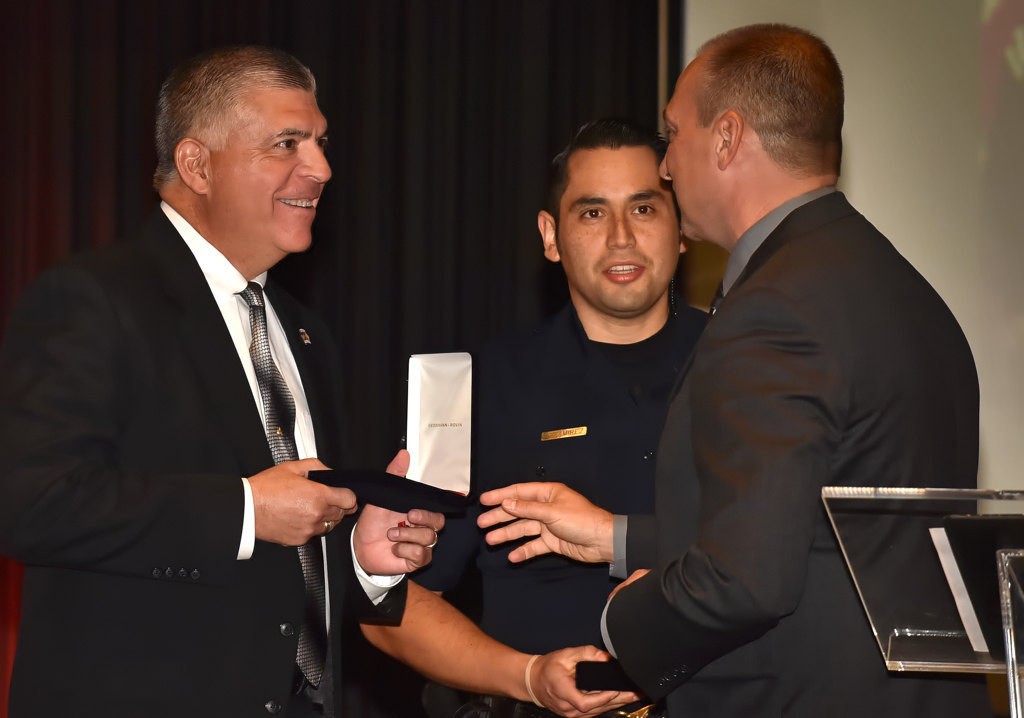 Officers Val Villarreal, left, and Anthony Ramirez receive the Distinguished Services Medal from Tustin Police Chief Charles Celano. Photo by Steven Georges/Behind the Badge OC